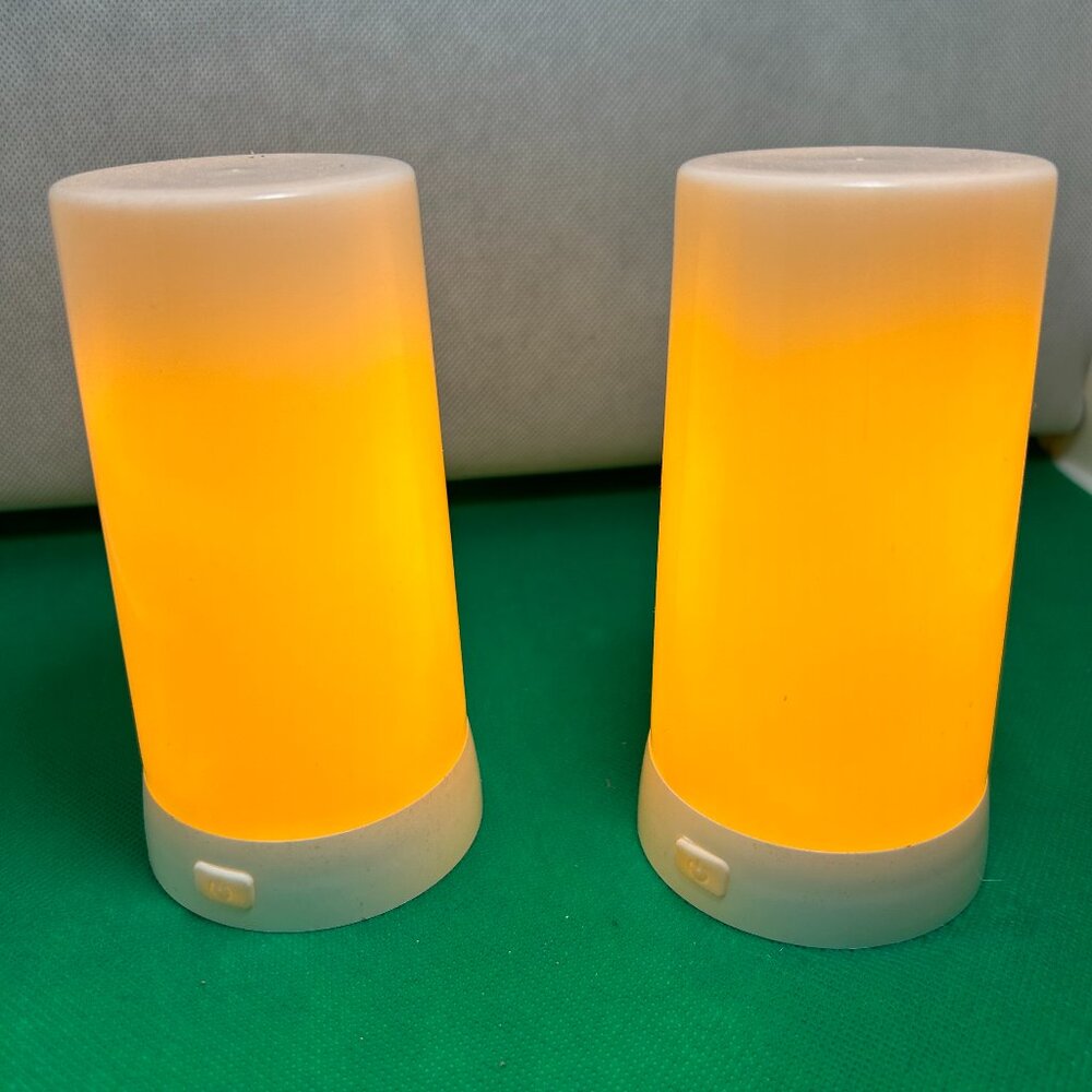 FIA Flame Candles. Set of 2, have 2 remotes and 1 box. Charging cables included.